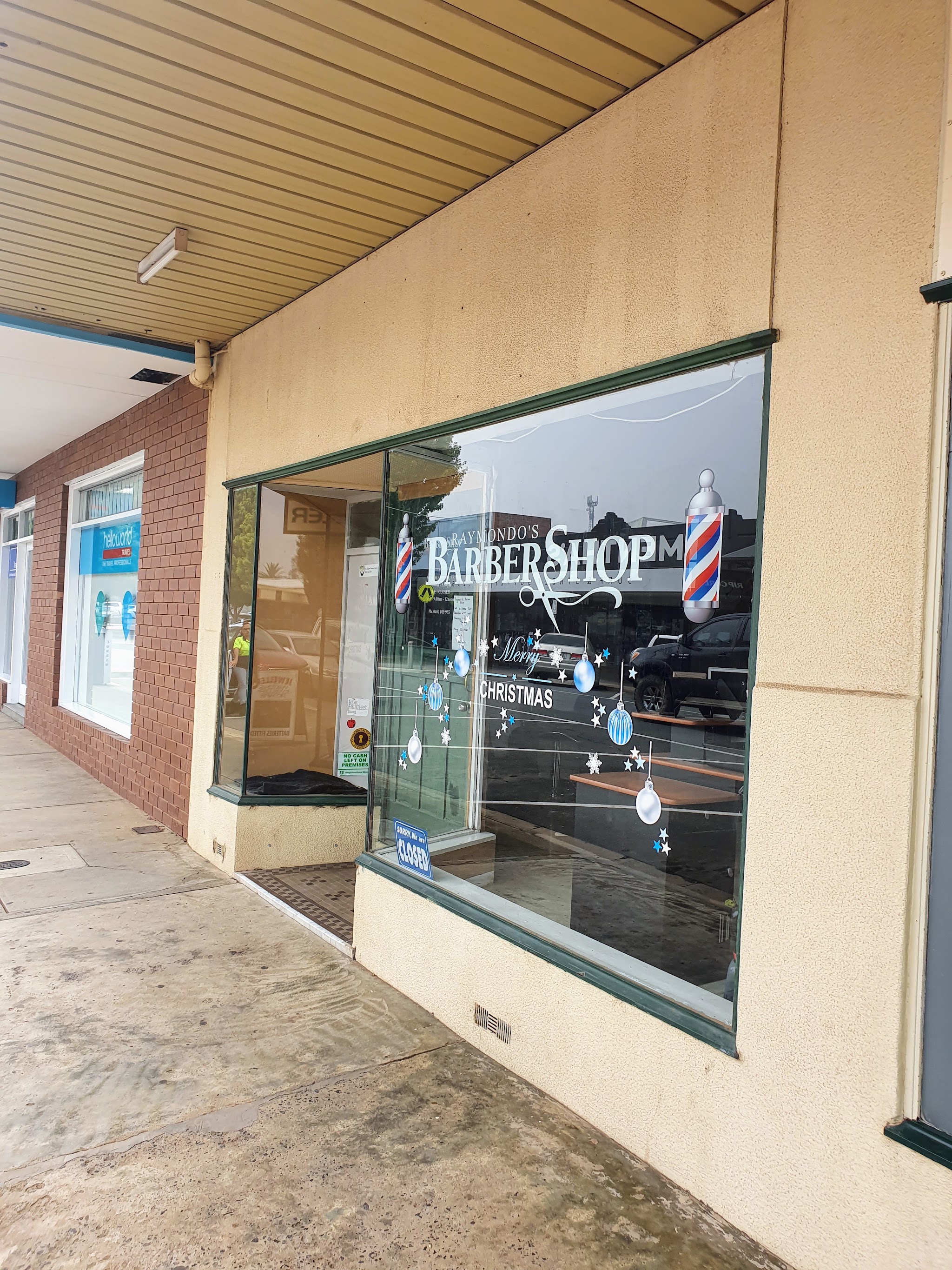 The shopfront of Raymondo’s Barber Shop under the Bank Street verandah